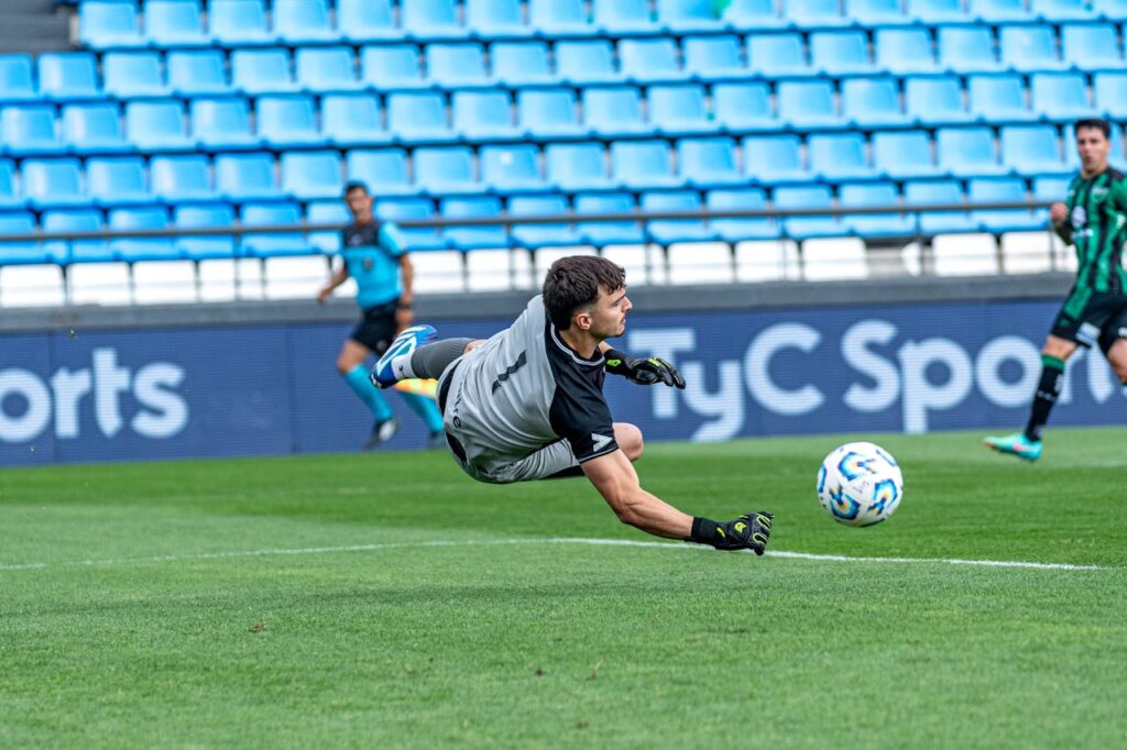 confident goalkeeper wearing gloves celebrating save